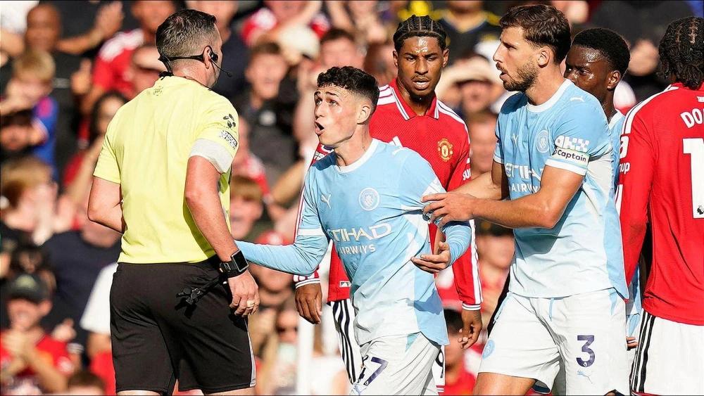 Phil Foden reacts after controversial Manchester derby red card